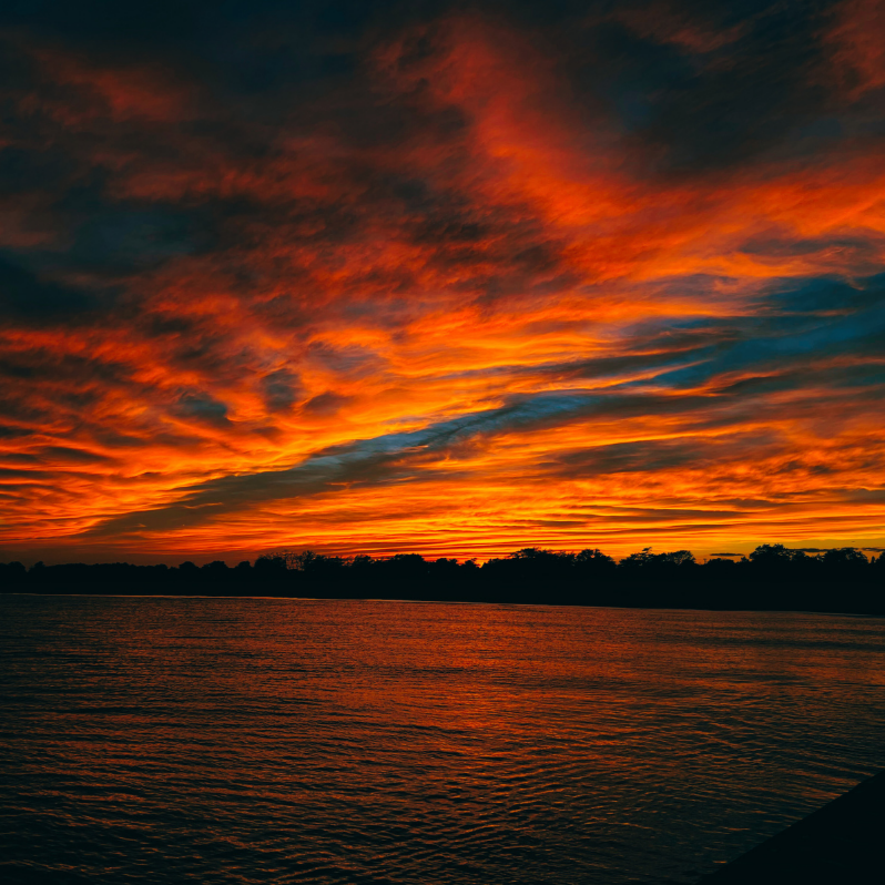 vivi & vela autumn equinox inspiration - warm-toned sunset over a calm lake