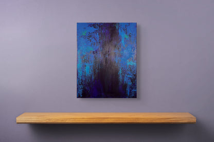 vivi & vela artwork display for 'midnight | moods': abstract artwork styled in a modern interior, showcasing vibrant blue tones and layered textures reminiscent of city lights at night.