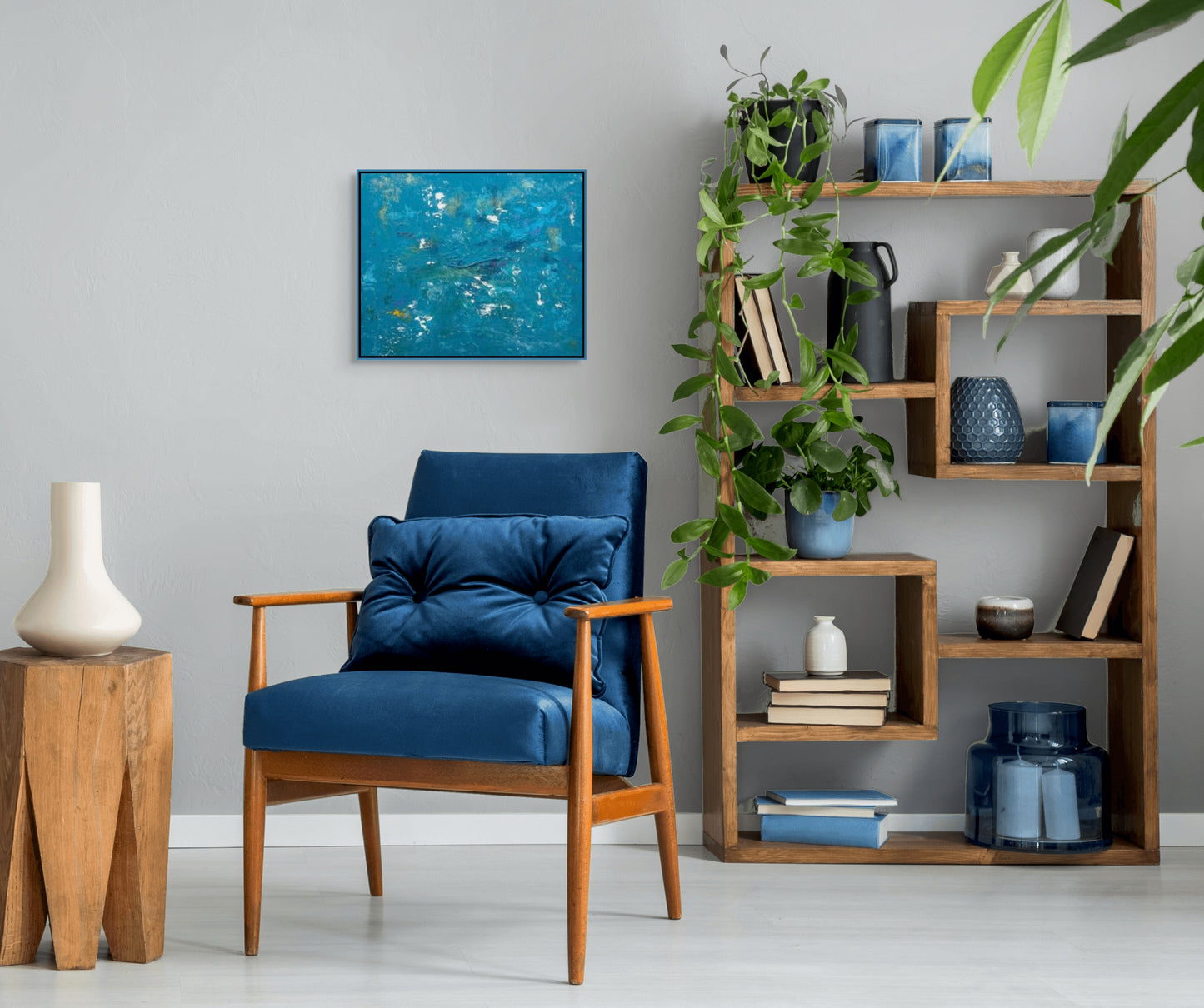 vivi & vela artwork display for 'summit': abstract artwork styled in a modern interior, showcasing its vibrant blue palette and textured terrain-like surface.